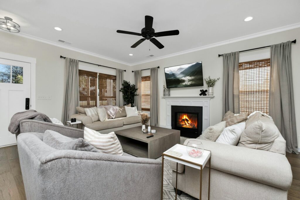 How to Keep Your House Warm This Winter Without Cranking the Heat 8 Living room with a ceiling fan and fireplace to keep the house warm in winter