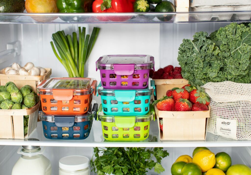 How to Properly Freeze Food Without Ruining the Taste or Texture 11 Colorful stacked food storage containers in an organized fridge